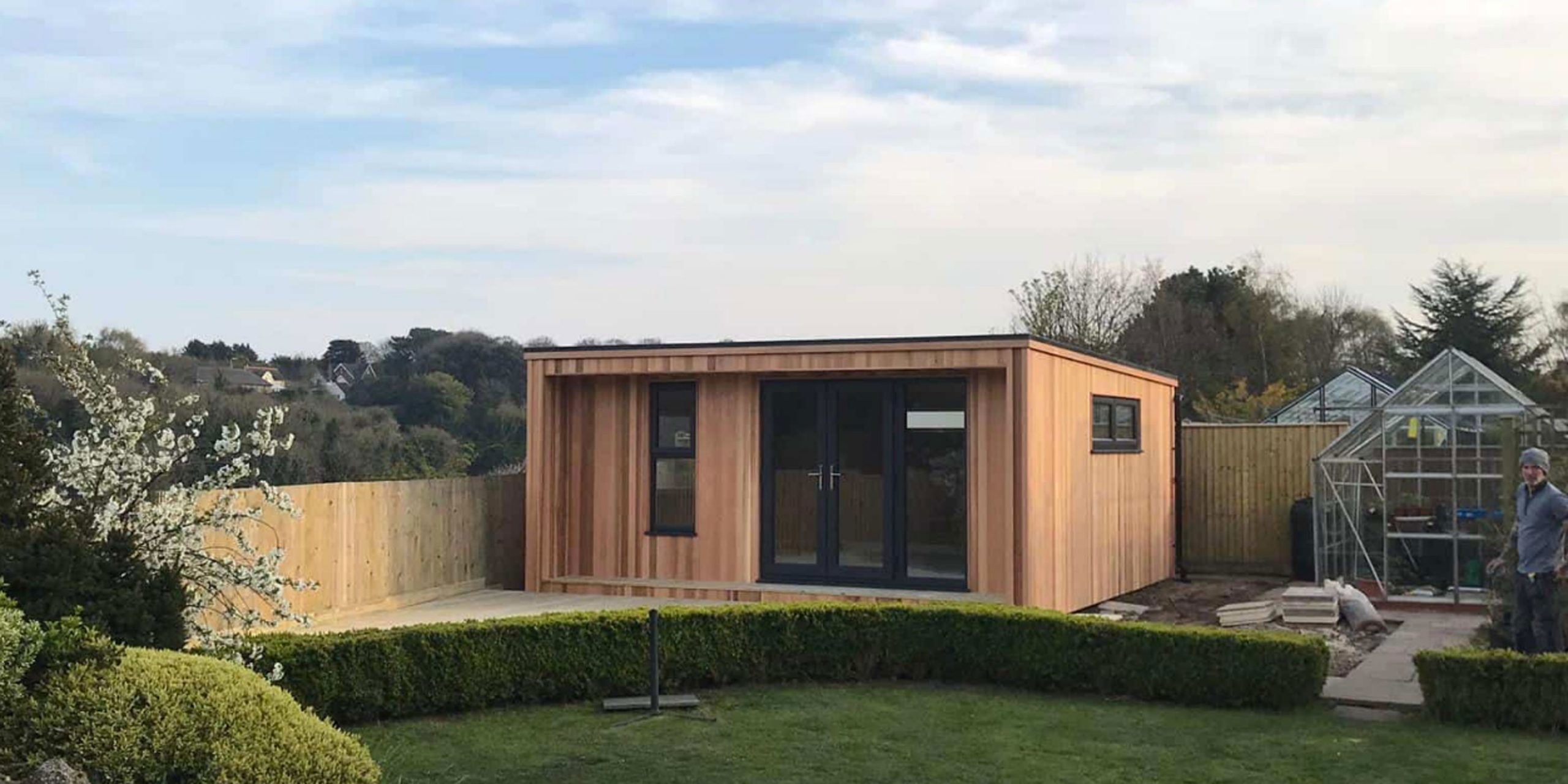 Image of a home office shed made by d gooch that has been installed in customer lovely garden