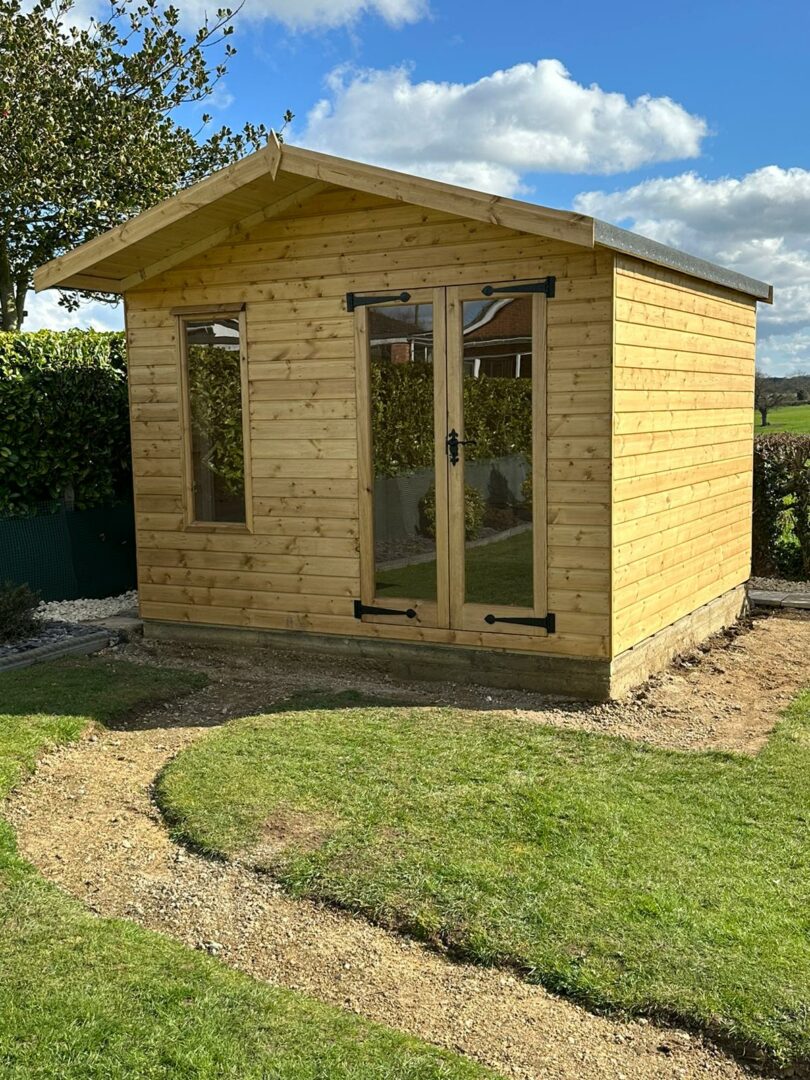 Garden Office in back garden with bi fold doors and vertical window