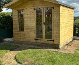 Garden Office in back garden with bi fold doors and vertical window